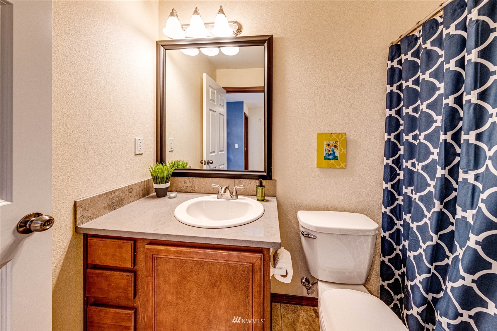 21318 11th Drive Southeast Bothell, WA 98021 - Photo 20 of 27 a bathroom with a toilet a sink and a mirror