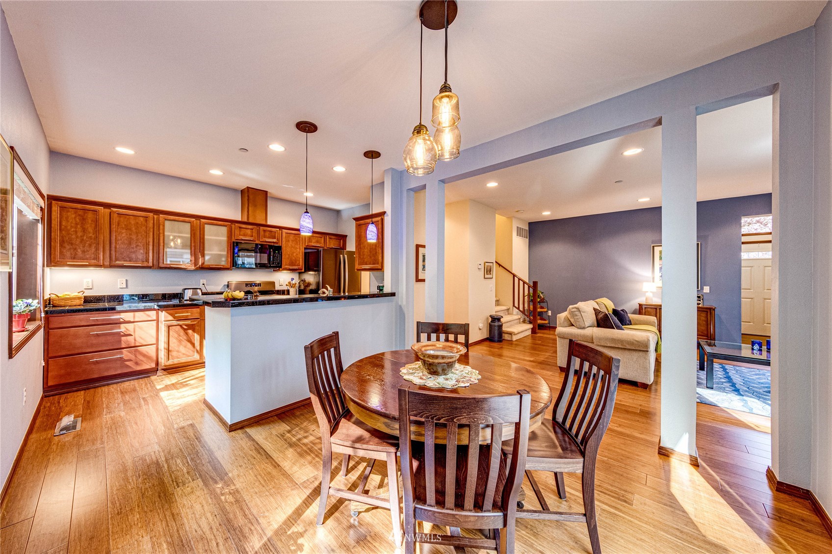 21318 11th Drive Southeast Bothell, WA 98021 - Photo 7 of 27 a dining room with stainless steel appliances kitchen island granite countertop a table and chairs