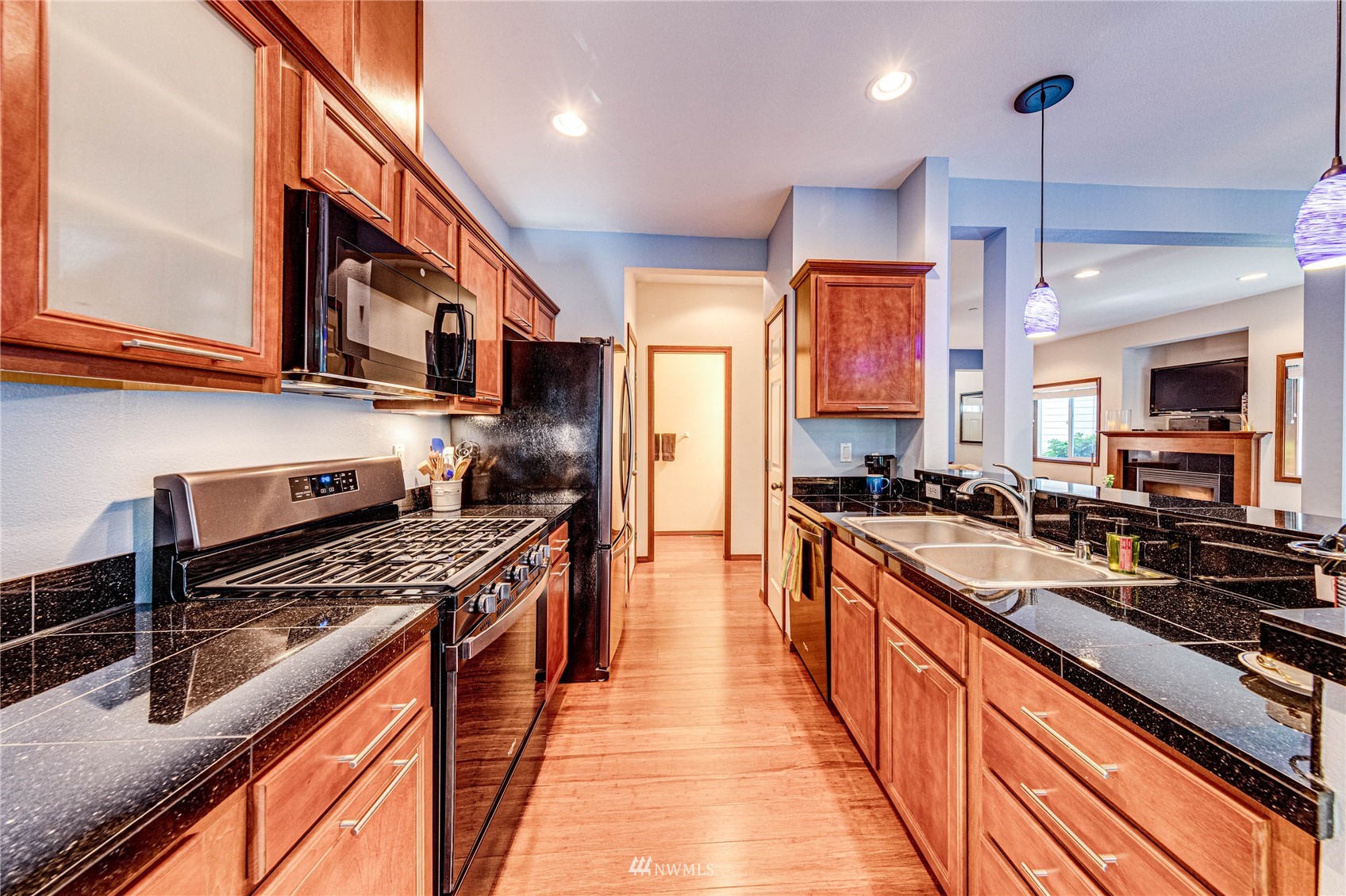 21318 11th Drive Southeast Bothell, WA 98021 - Photo 8 of 27 a kitchen with stainless steel appliances granite countertop a stove a sink and a refrigerator