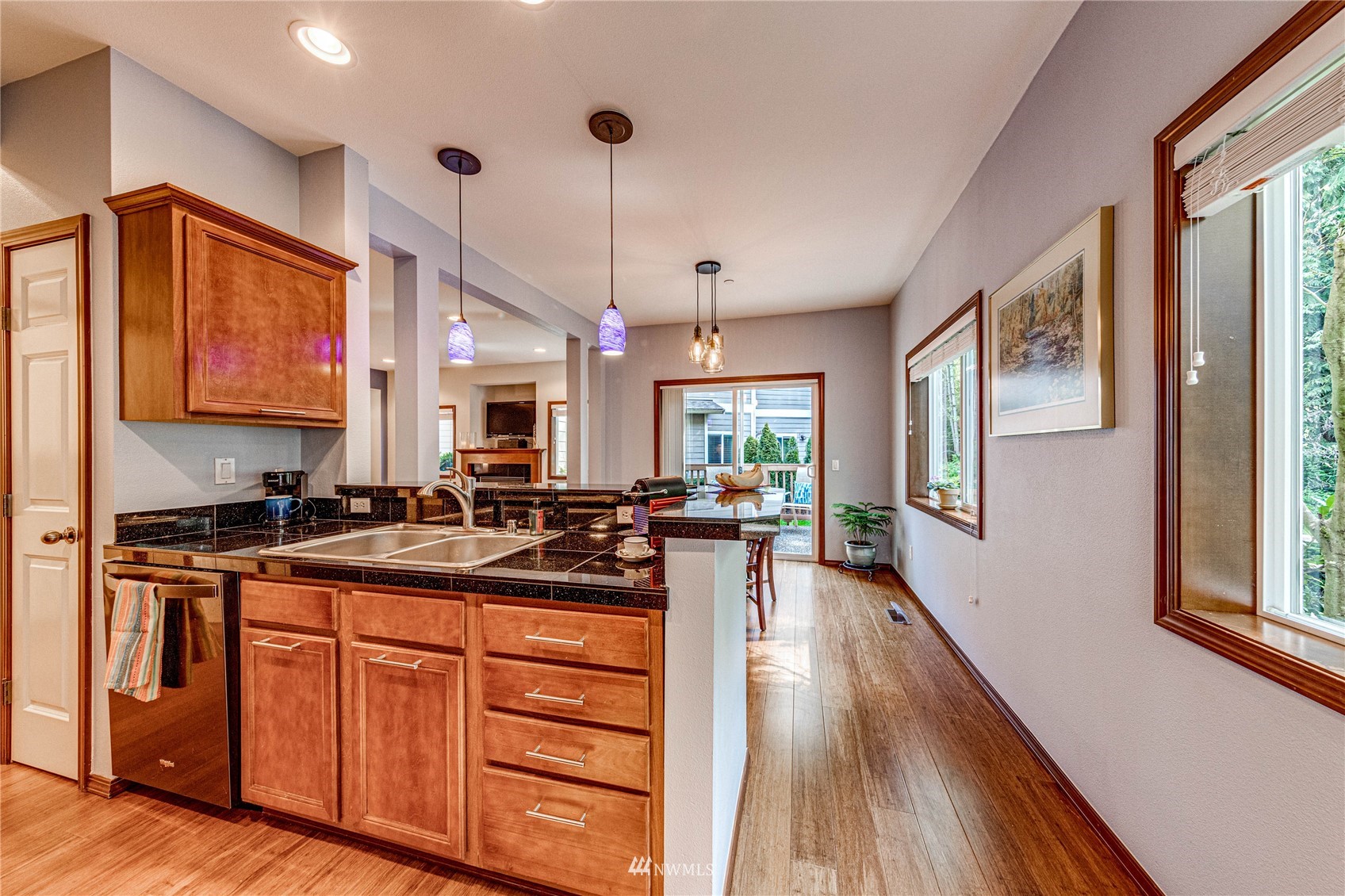 21318 11th Drive Southeast Bothell, WA 98021 - Photo 9 of 27 a kitchen with stainless steel appliances granite countertop a stove a sink dishwasher and a refrigerator with wooden floor
