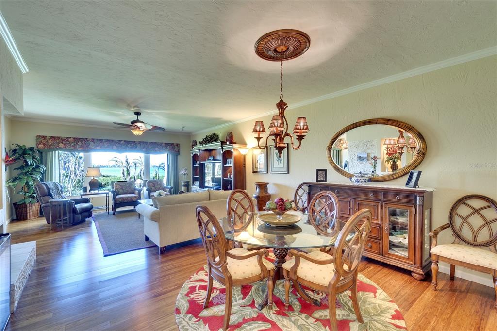 3920 Mariners Way, Unit 311C Cortez, FL 34215 - Photo 19 of 35 a view of a dining room with furniture window and wooden floor