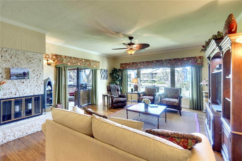 3920 Mariners Way, Unit 311C Cortez, FL 34215 - Photo 21 of 35 a living room with furniture and a fireplace
