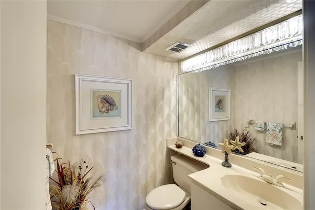 a bathroom with a sink toilet and mirror