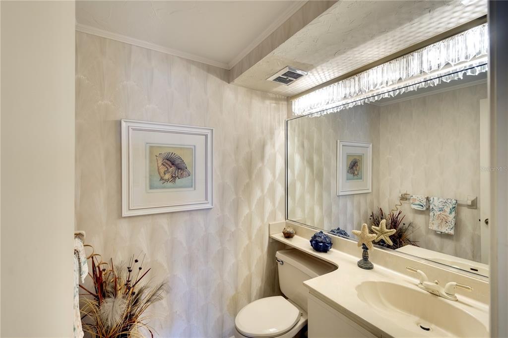 3920 Mariners Way, Unit 311C Cortez, FL 34215 - Photo 5 of 35 a bathroom with a sink toilet and mirror