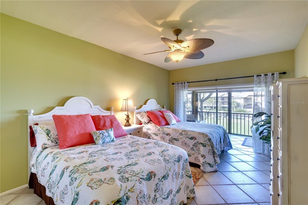 3920 Mariners Way, Unit 311C Cortez, FL 34215 - Photo 8 of 35 a bedroom with a large bed and a chandelier