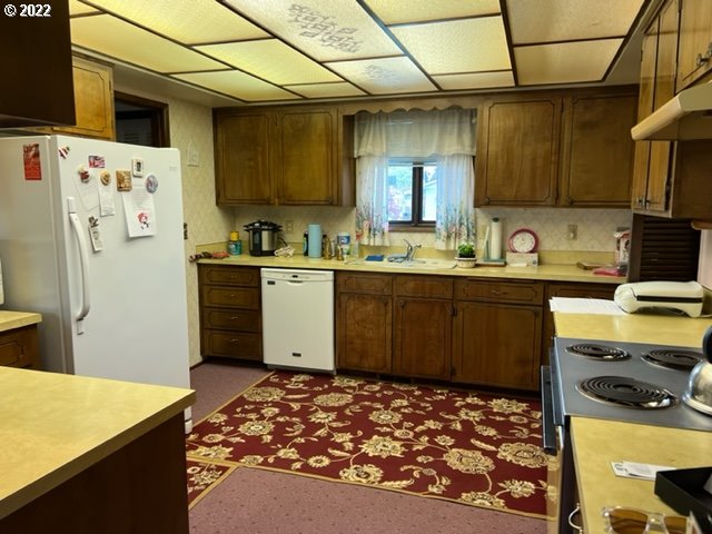 2136 Loch Drive Springfield, OR 97477 - Photo 8 of 11 a kitchen with a sink and wooden cabinets