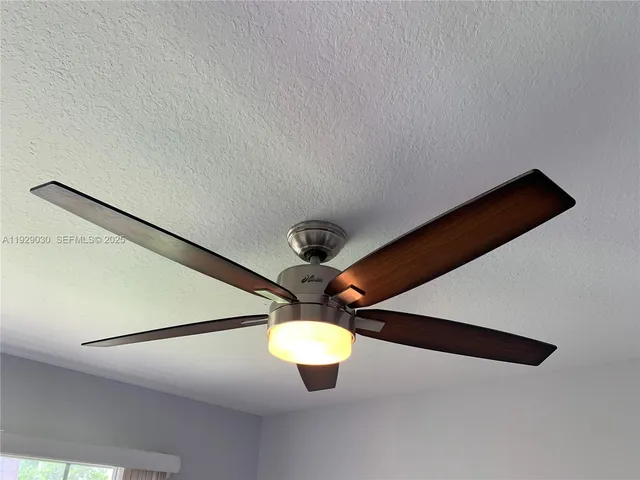 a view of a ceiling fan and table in a room