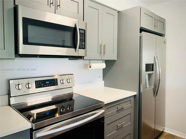 a kitchen with a microwave stove and microwave
