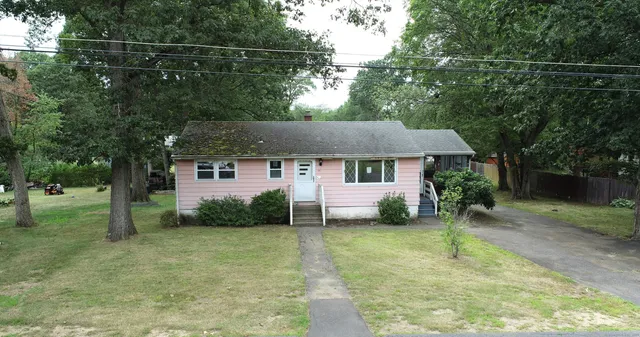 a aerial view of a house with a yard and a garage