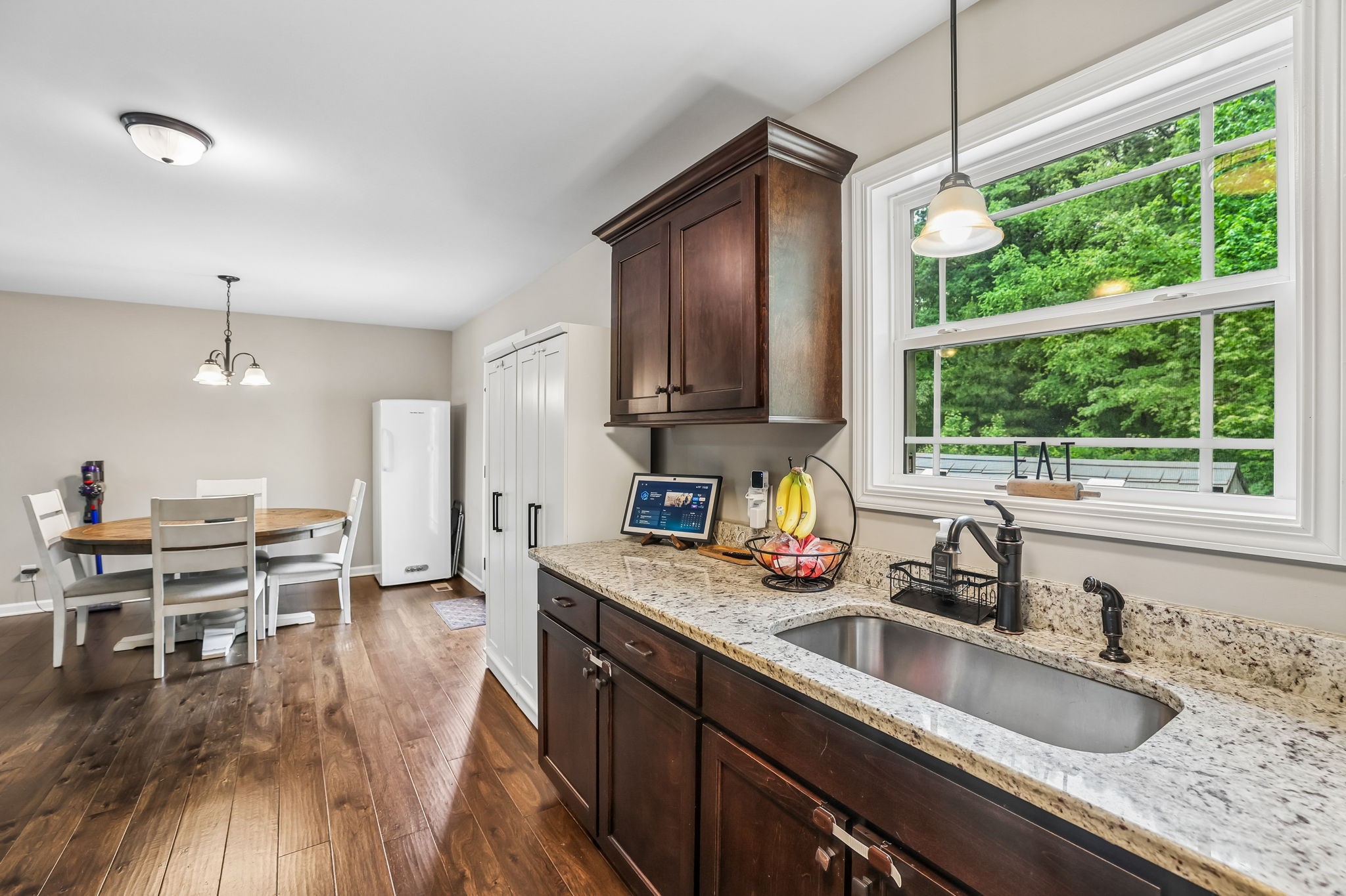 1546 South Spring Street Manchester, TN 37355 - Photo 24 of 53 a kitchen with stainless steel appliances granite countertop a sink a stove a dining table and chairs with wooden floor