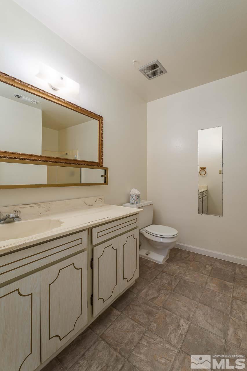 2300 Dickerson Road, Unit 36 Reno, NV 89503 - Photo 17 of 25 a spacious bathroom with a toilet sink and mirror