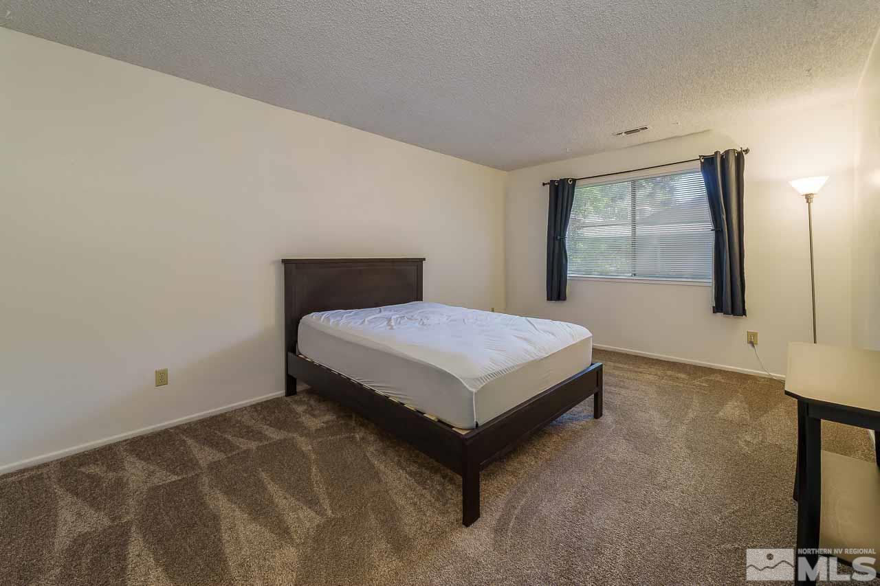 2300 Dickerson Road, Unit 36 Reno, NV 89503 - Photo 20 of 25 a bedroom with a bed and window