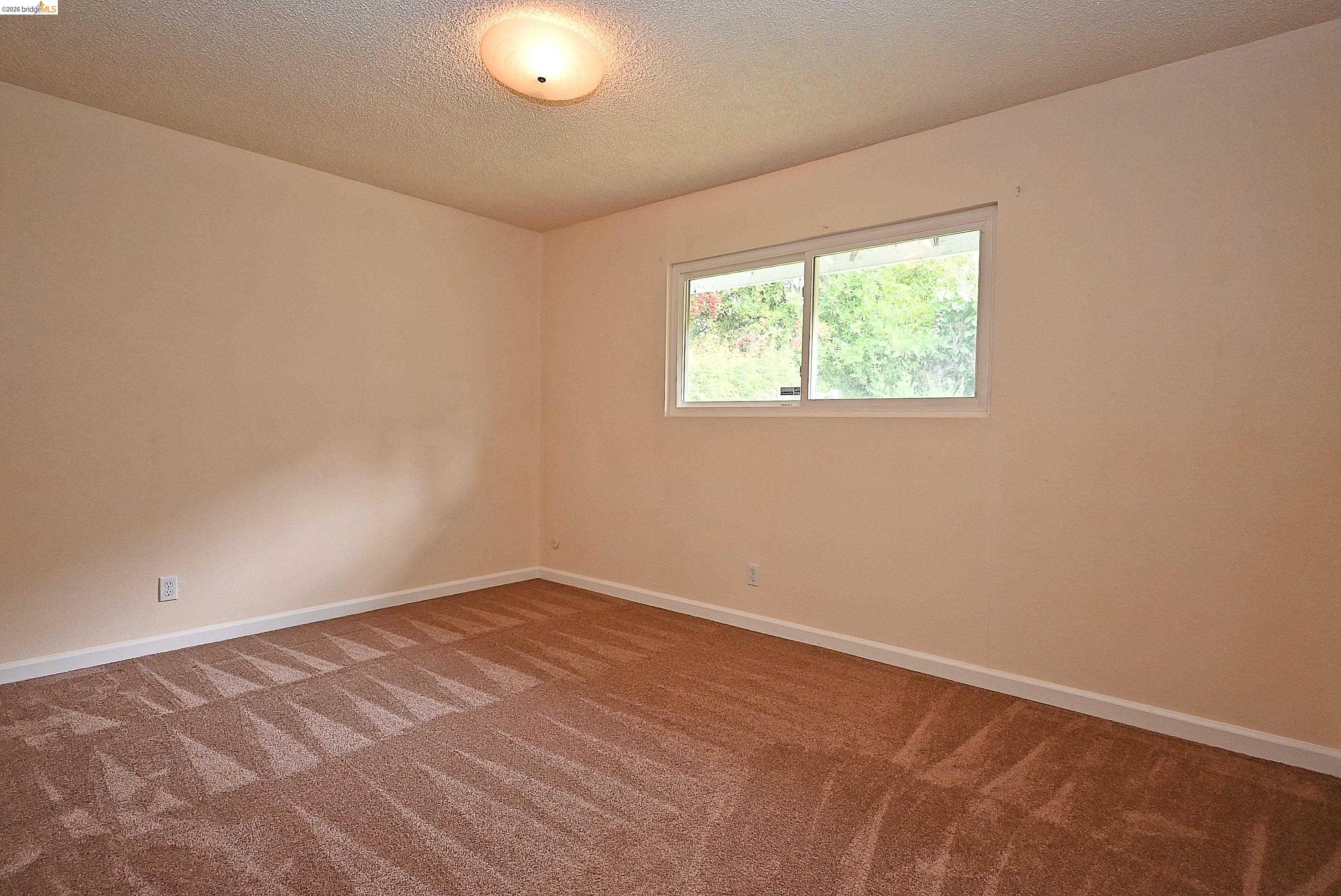 159 Coleridge Drive Vallejo, CA 94591 - Photo 24 of 33 Carpeted empty room featuring baseboards and a textured ceiling