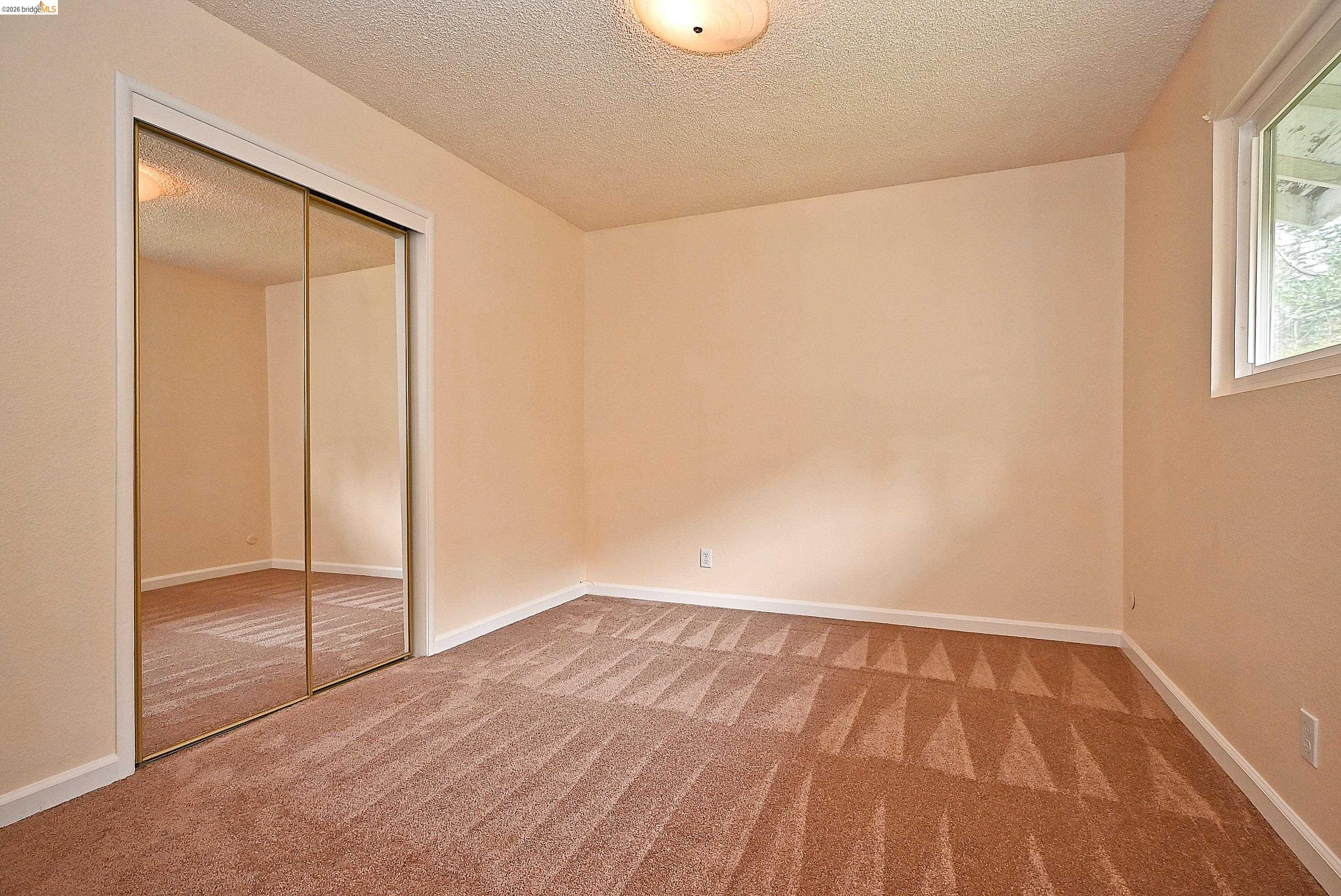 159 Coleridge Drive Vallejo, CA 94591 - Photo 25 of 33 Unfurnished bedroom featuring a closet, a textured ceiling, and carpet flooring