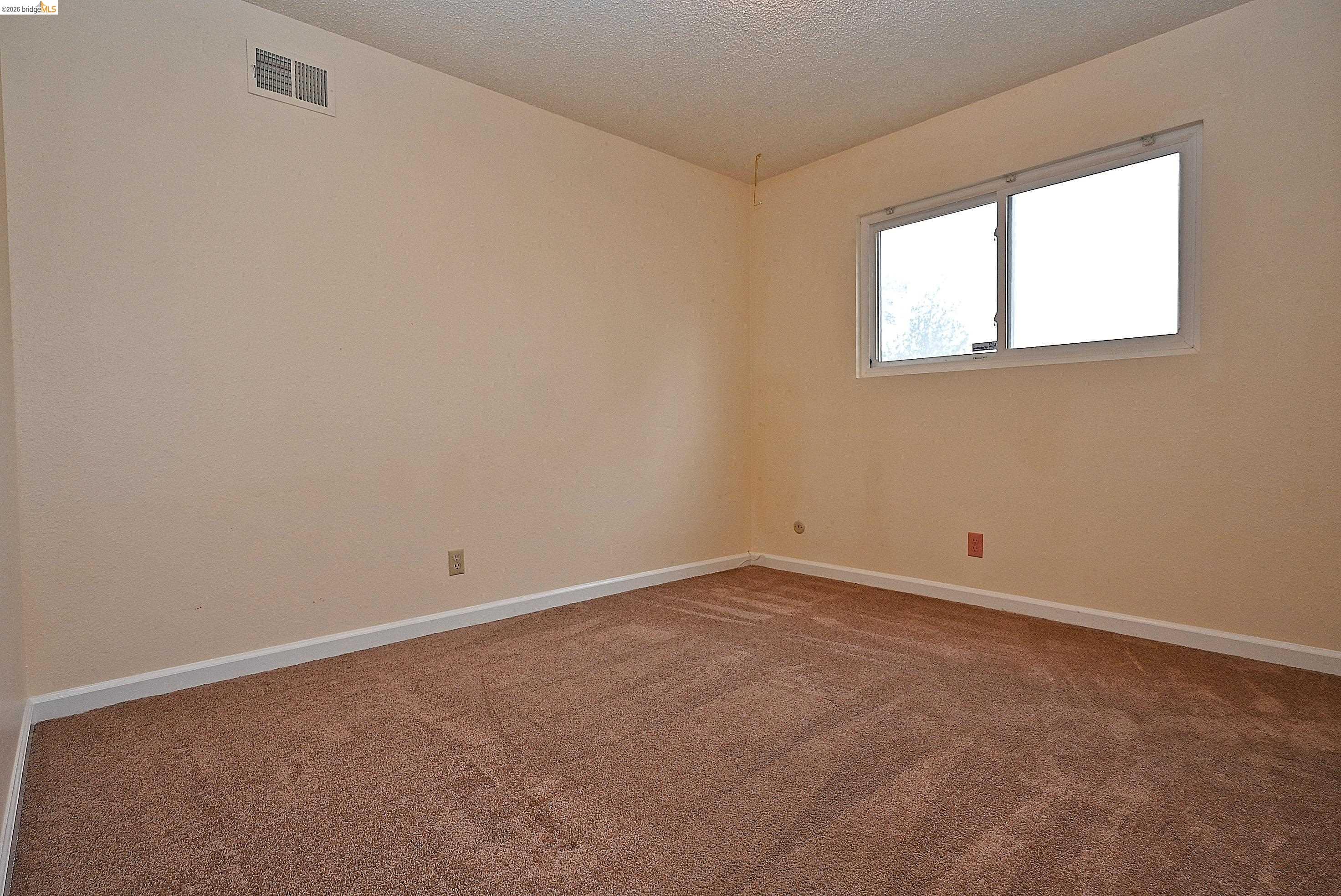 159 Coleridge Drive Vallejo, CA 94591 - Photo 26 of 33 Carpeted empty room featuring baseboards and a textured ceiling