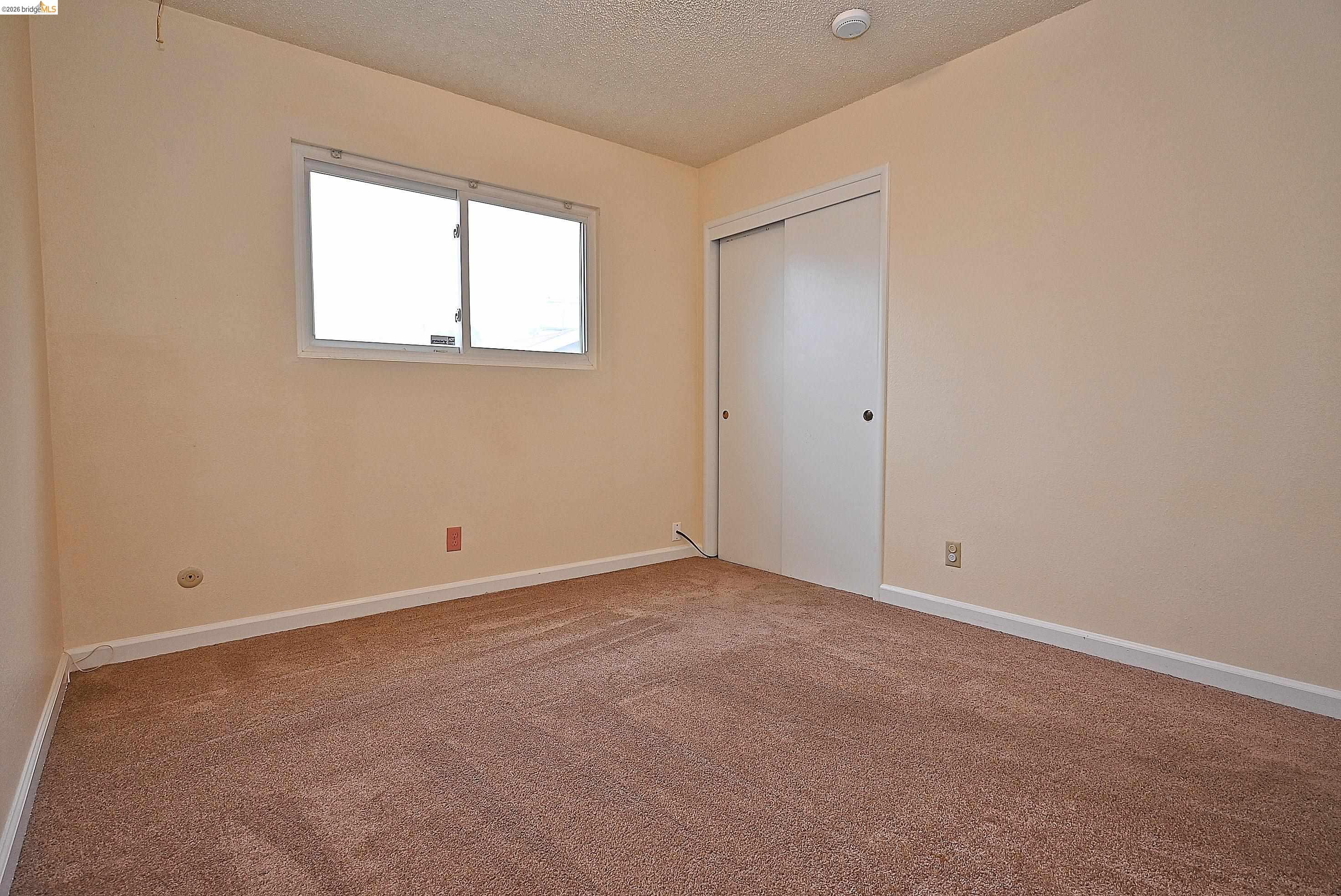 159 Coleridge Drive Vallejo, CA 94591 - Photo 27 of 33 Unfurnished bedroom with carpet floors, a textured ceiling, and a closet