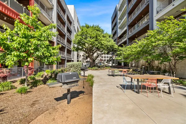 a view of a patio with a table and chairs and potted plants