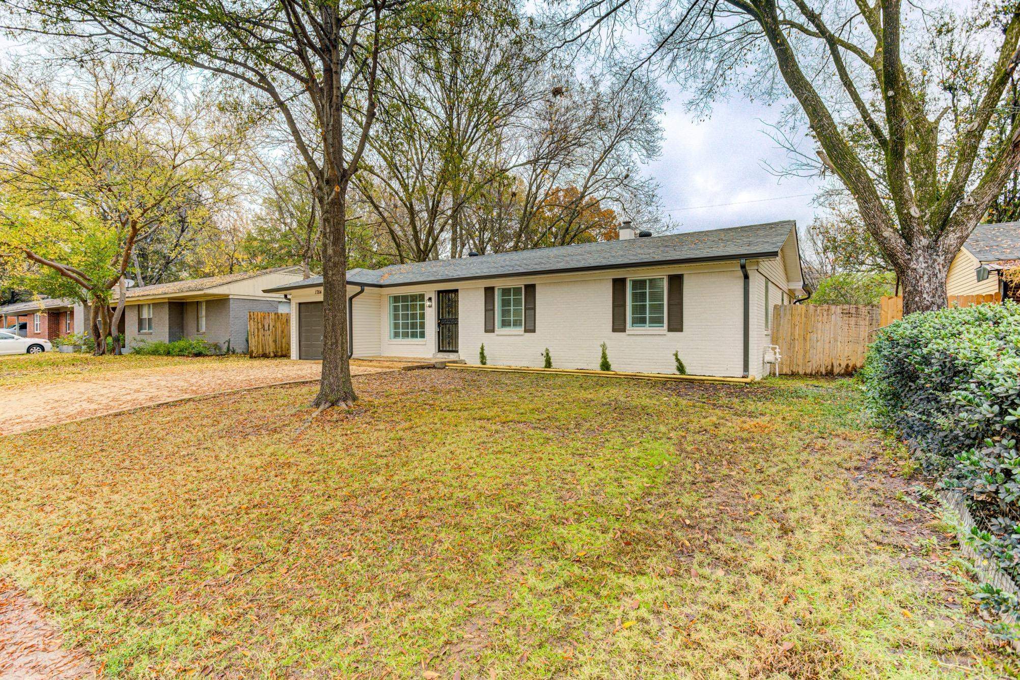 1784 Sea Isle Road Memphis, TN 38117 - Photo 3 of 27 Ranch-style home featuring concrete driveway, brick siding, and a chimney