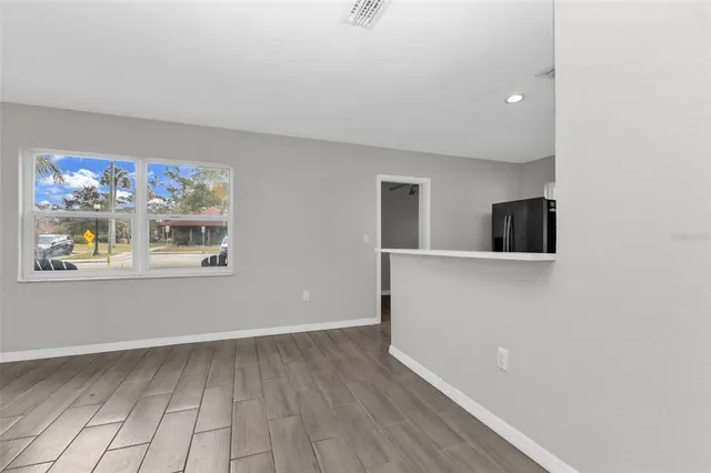 a view of a room with wooden floor and cabinet