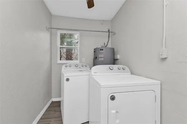 a view of an empty room with window and closet area