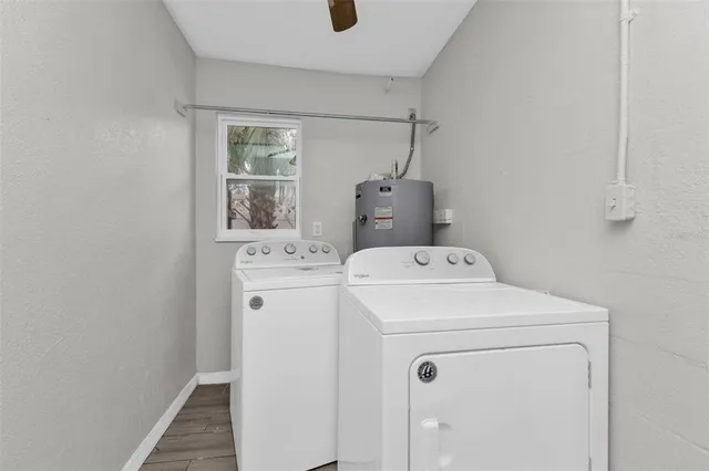 a view of an empty room with window and closet area