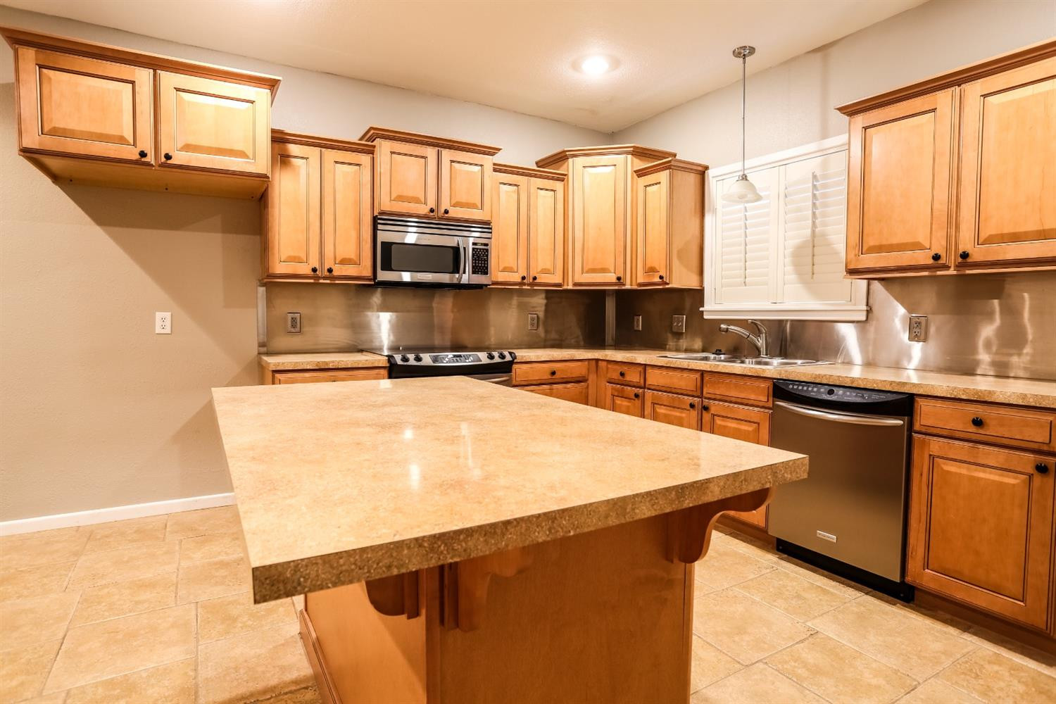 4831 10th Street Lubbock, TX 79416 - Photo 11 of 40 a kitchen with stainless steel appliances a sink stove and microwave