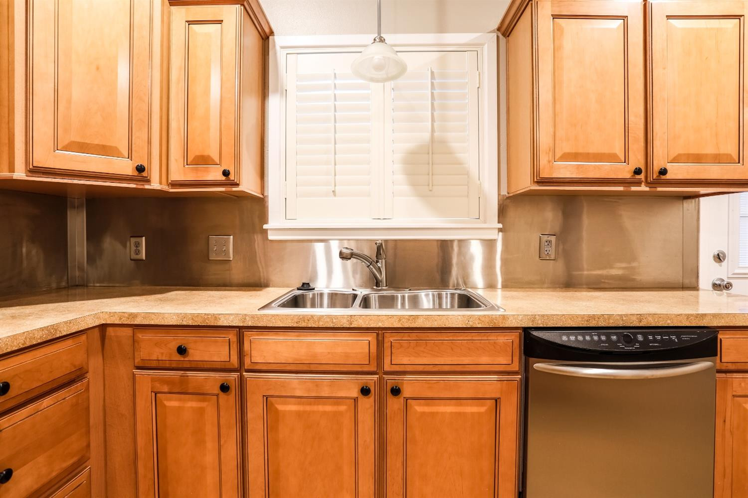 4831 10th Street Lubbock, TX 79416 - Photo 13 of 40 a kitchen with stainless steel appliances granite countertop a sink and a window