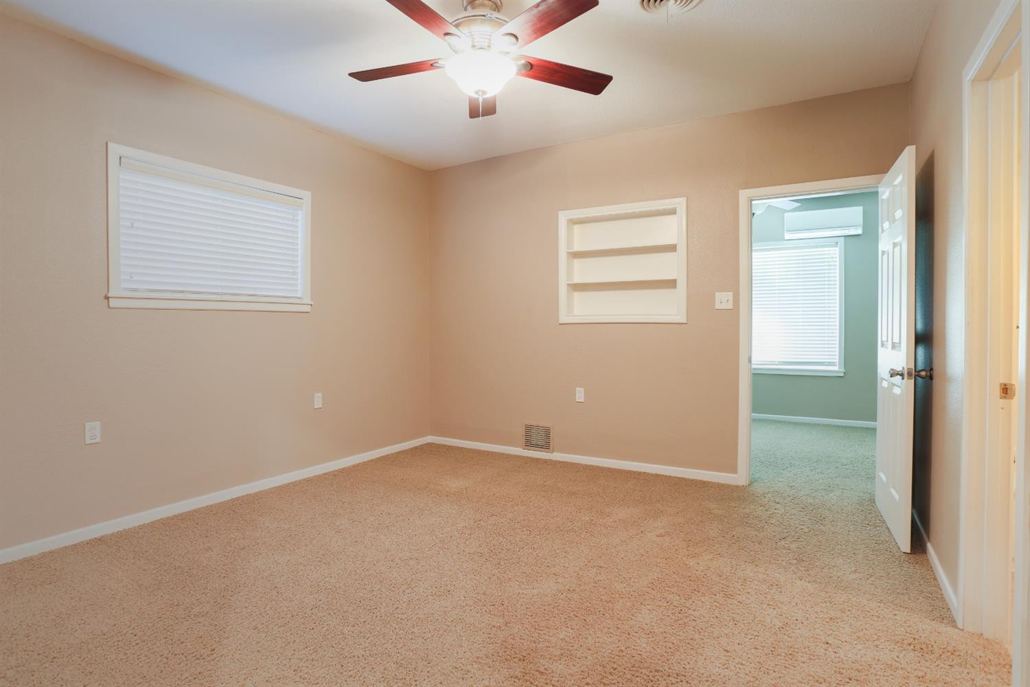 4831 10th Street Lubbock, TX 79416 - Photo 18 of 40 an empty room with windows and fan