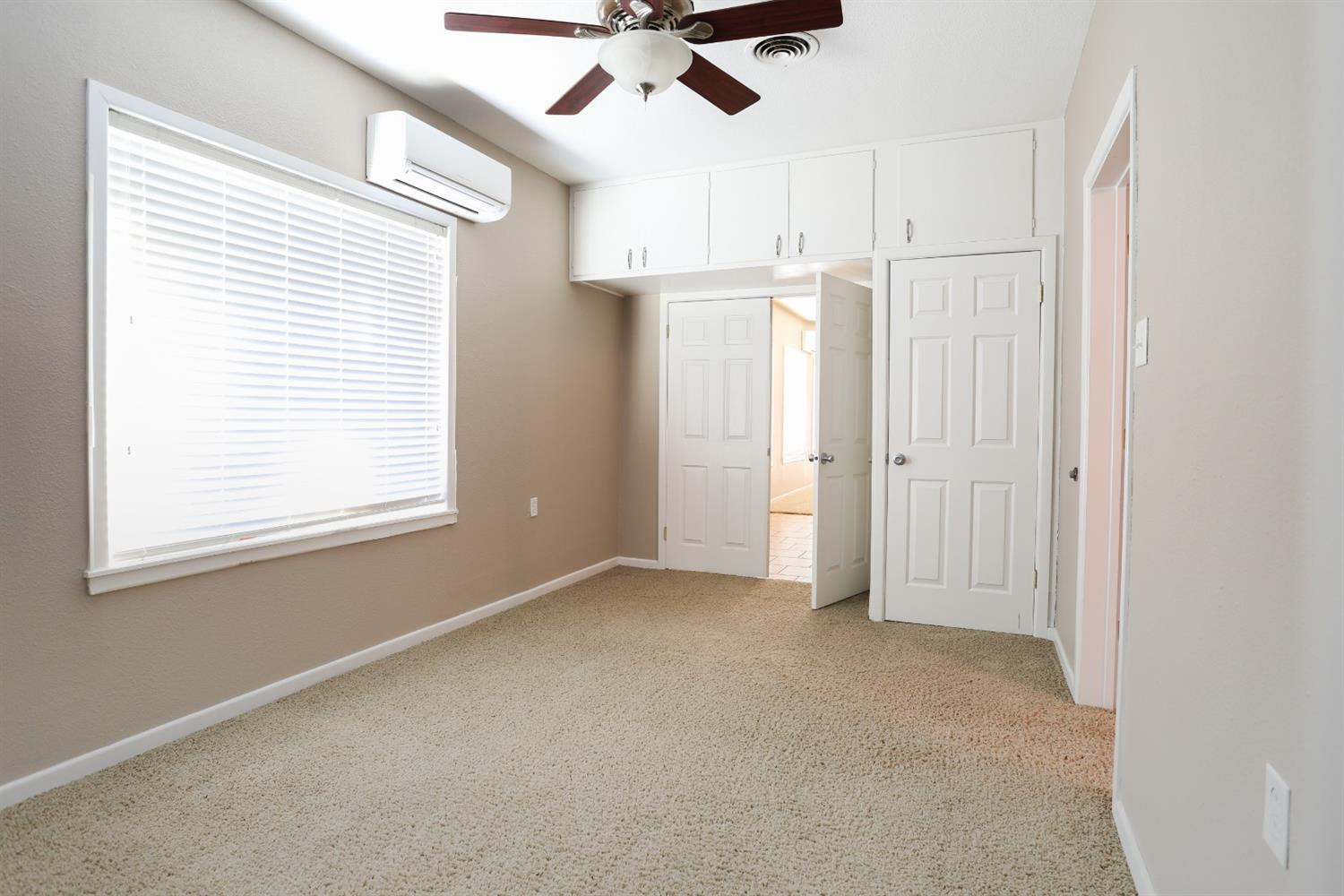 4831 10th Street Lubbock, TX 79416 - Photo 23 of 40 an empty room with a window and a ceiling fan