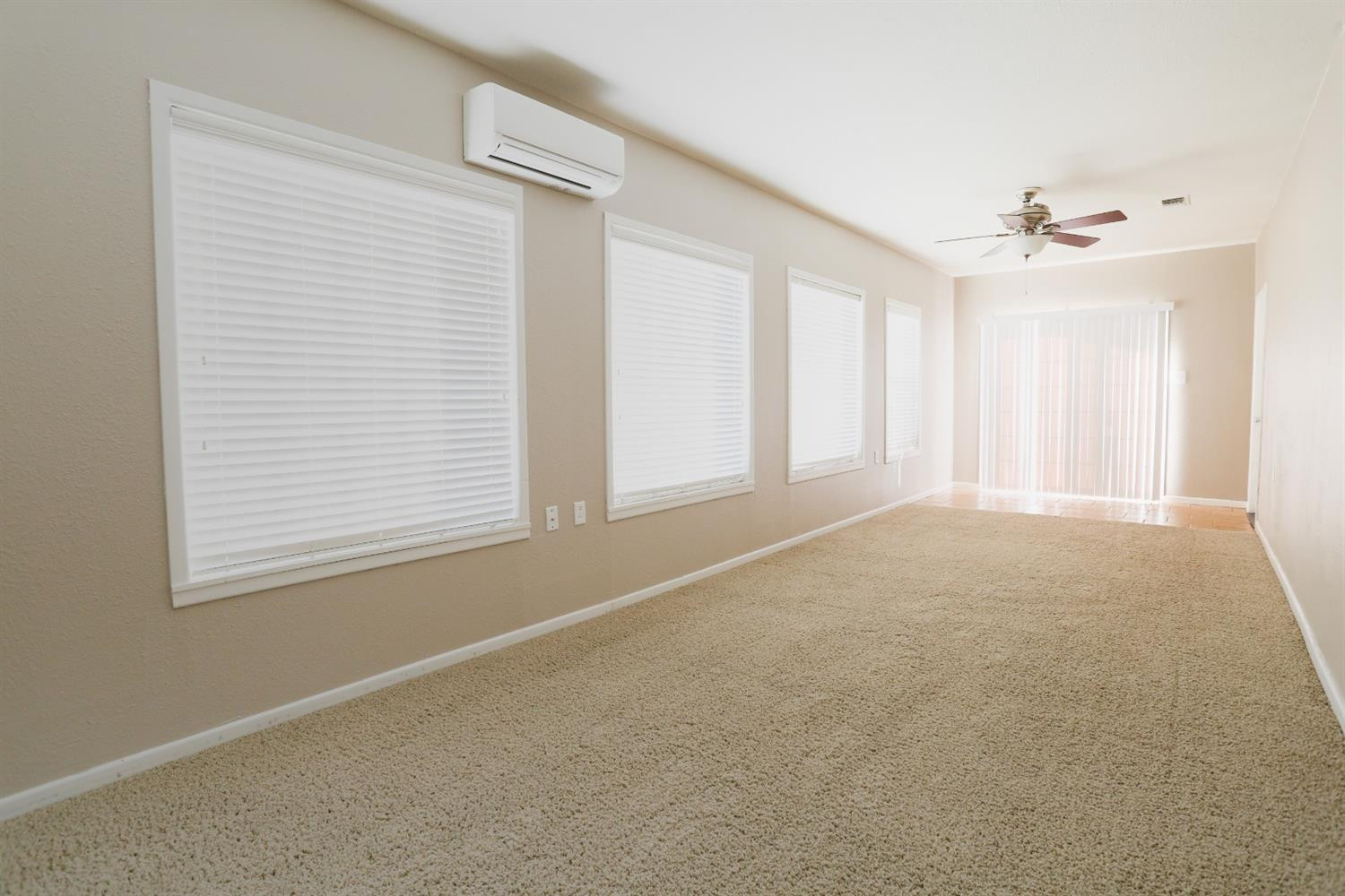 4831 10th Street Lubbock, TX 79416 - Photo 25 of 40 an empty room with windows and fan