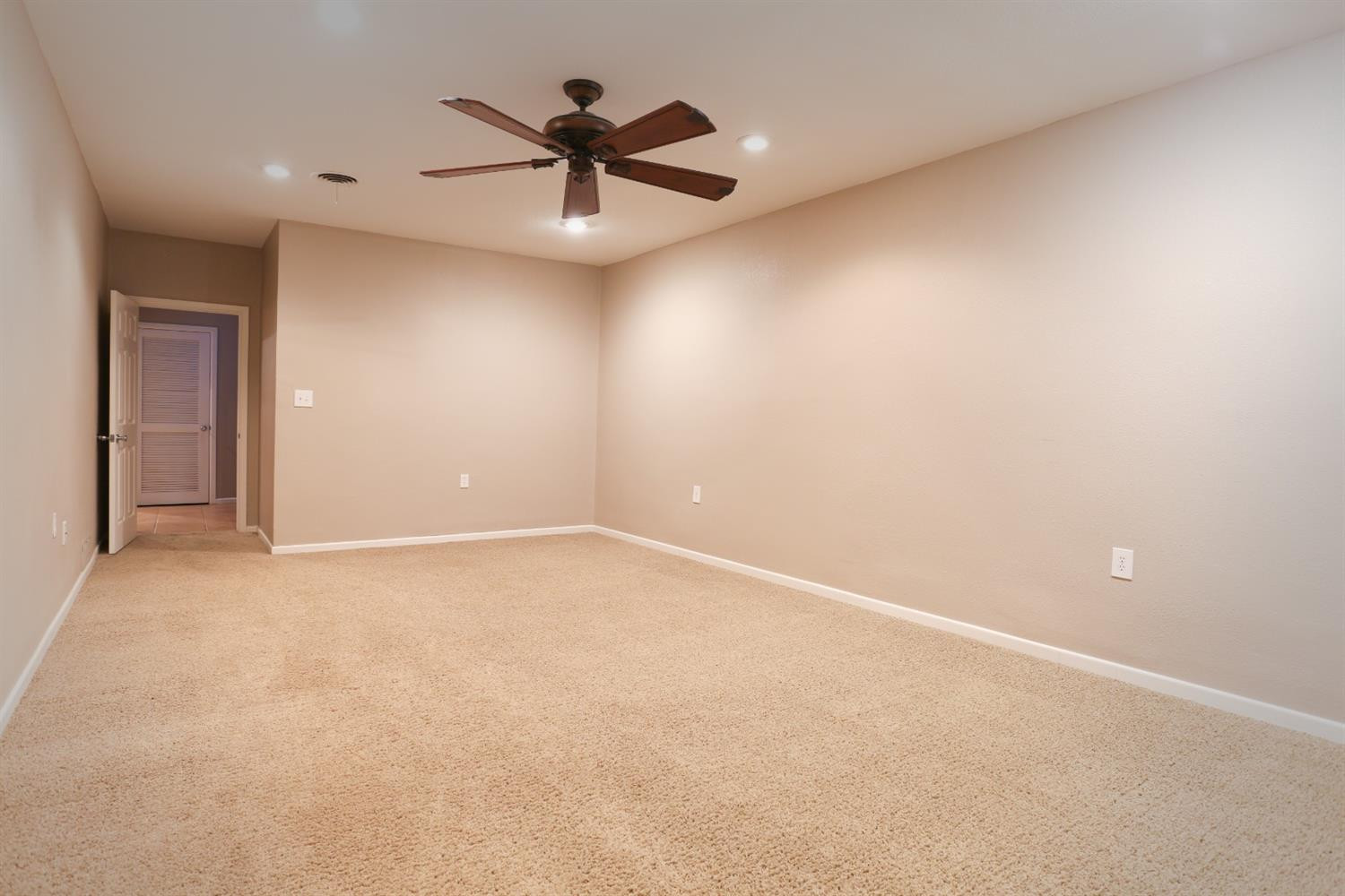4831 10th Street Lubbock, TX 79416 - Photo 26 of 40 an empty room with a ceiling fan and window