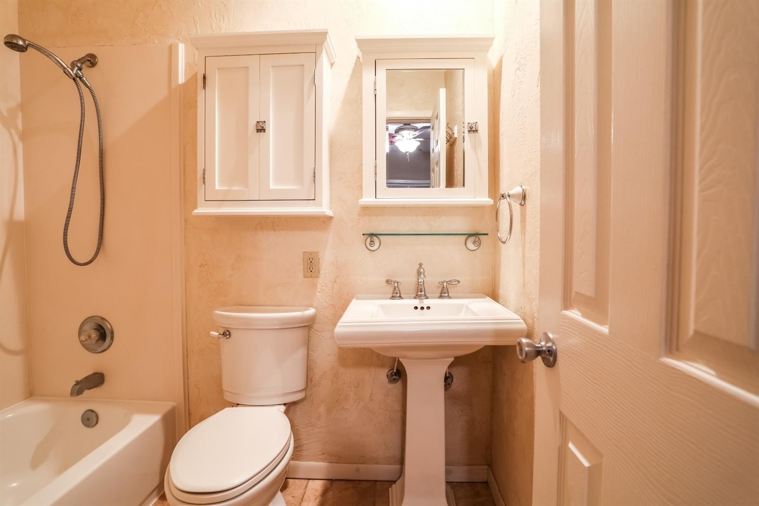 4831 10th Street Lubbock, TX 79416 - Photo 29 of 40 a bathroom with a sink a toilet and shower curtain