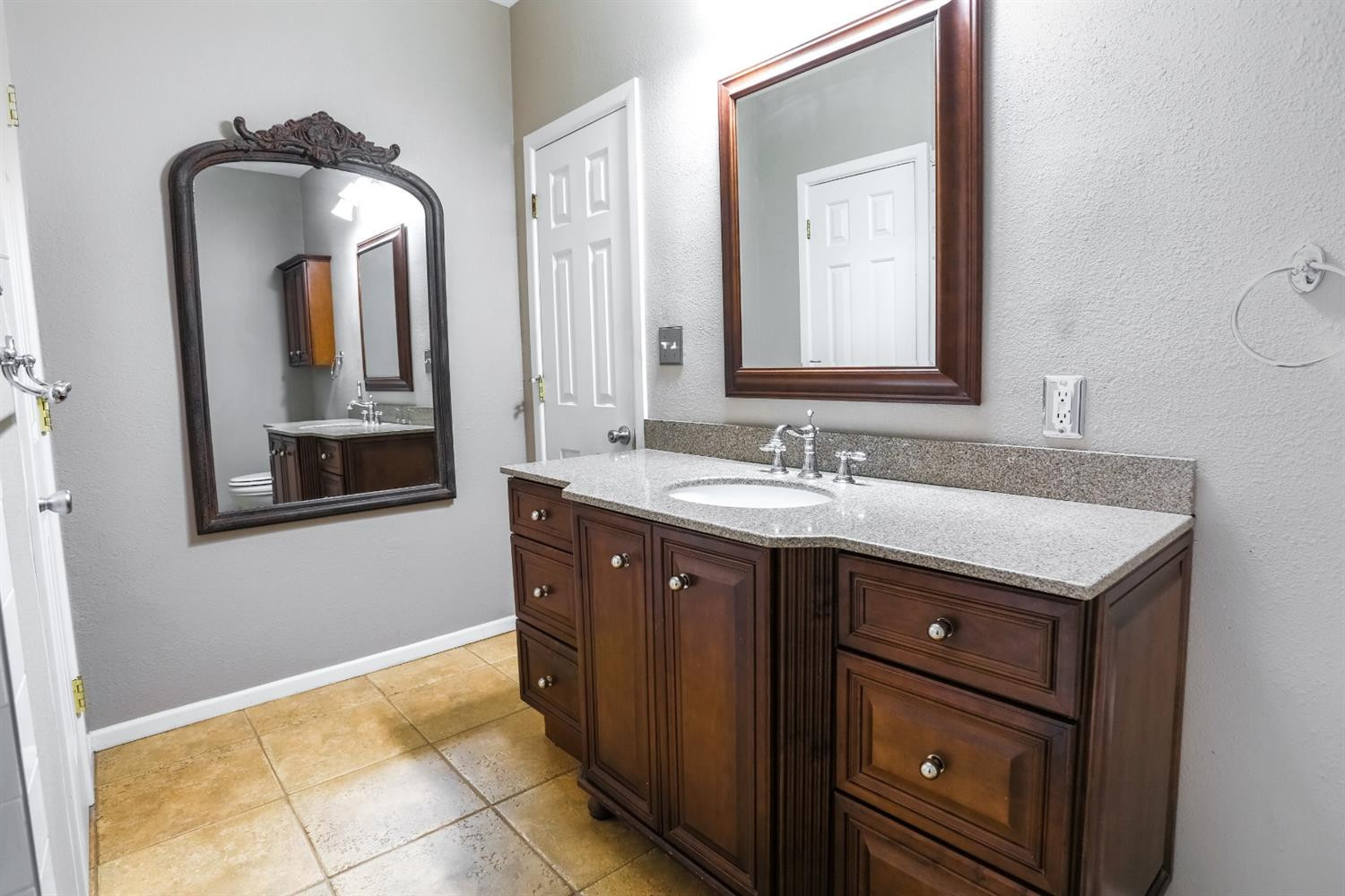 4831 10th Street Lubbock, TX 79416 - Photo 32 of 40 a bathroom with a double vanity sink and mirror