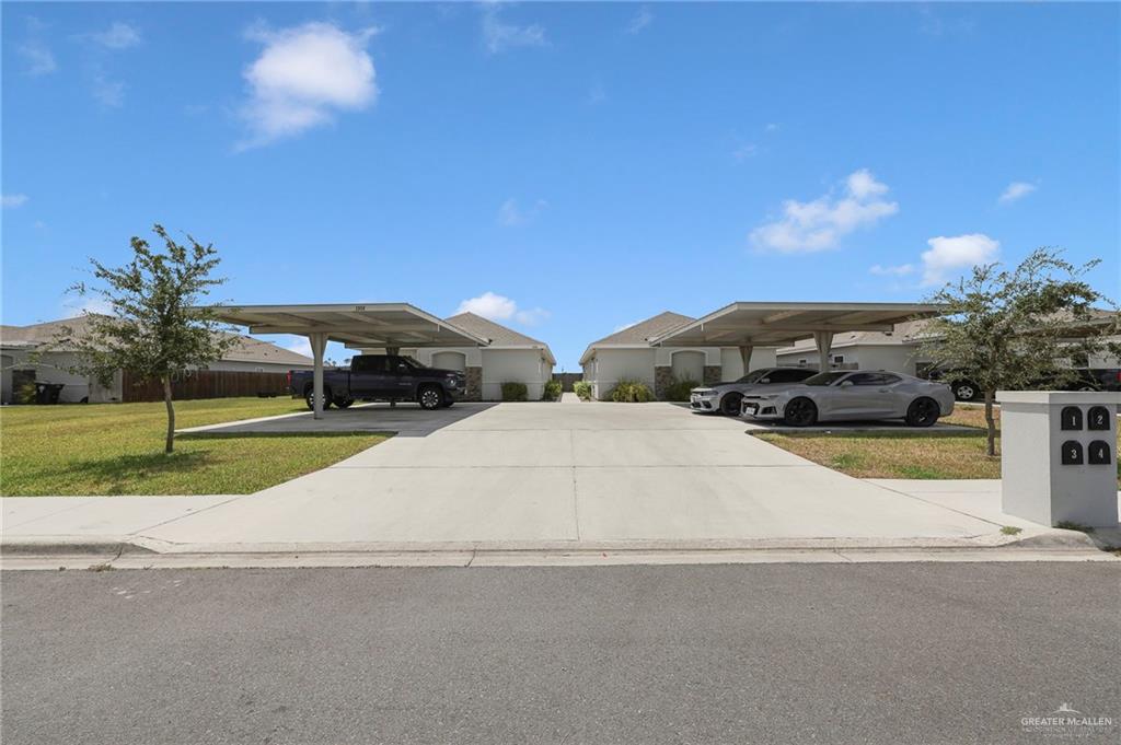 1912 Stauffers Street, Unit 1 Weslaco, TX 78596 - Photo 1 of 14 a couple of cars parked in front of a building