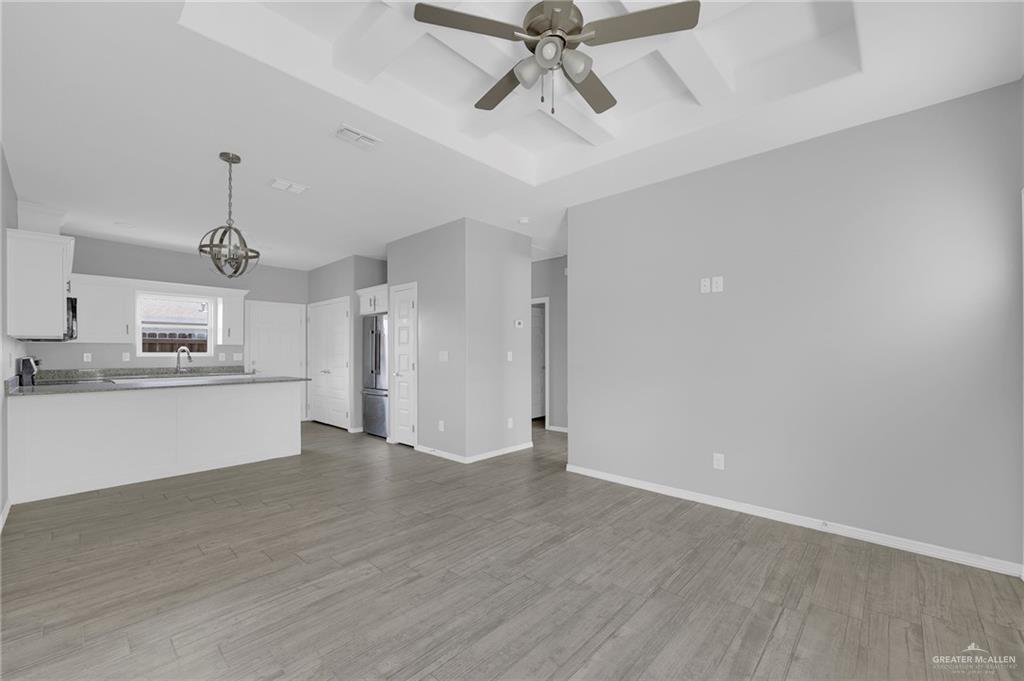 1912 Stauffers Street, Unit 1 Weslaco, TX 78596 - Photo 4 of 14 a view of a kitchen with wooden floor and a sink