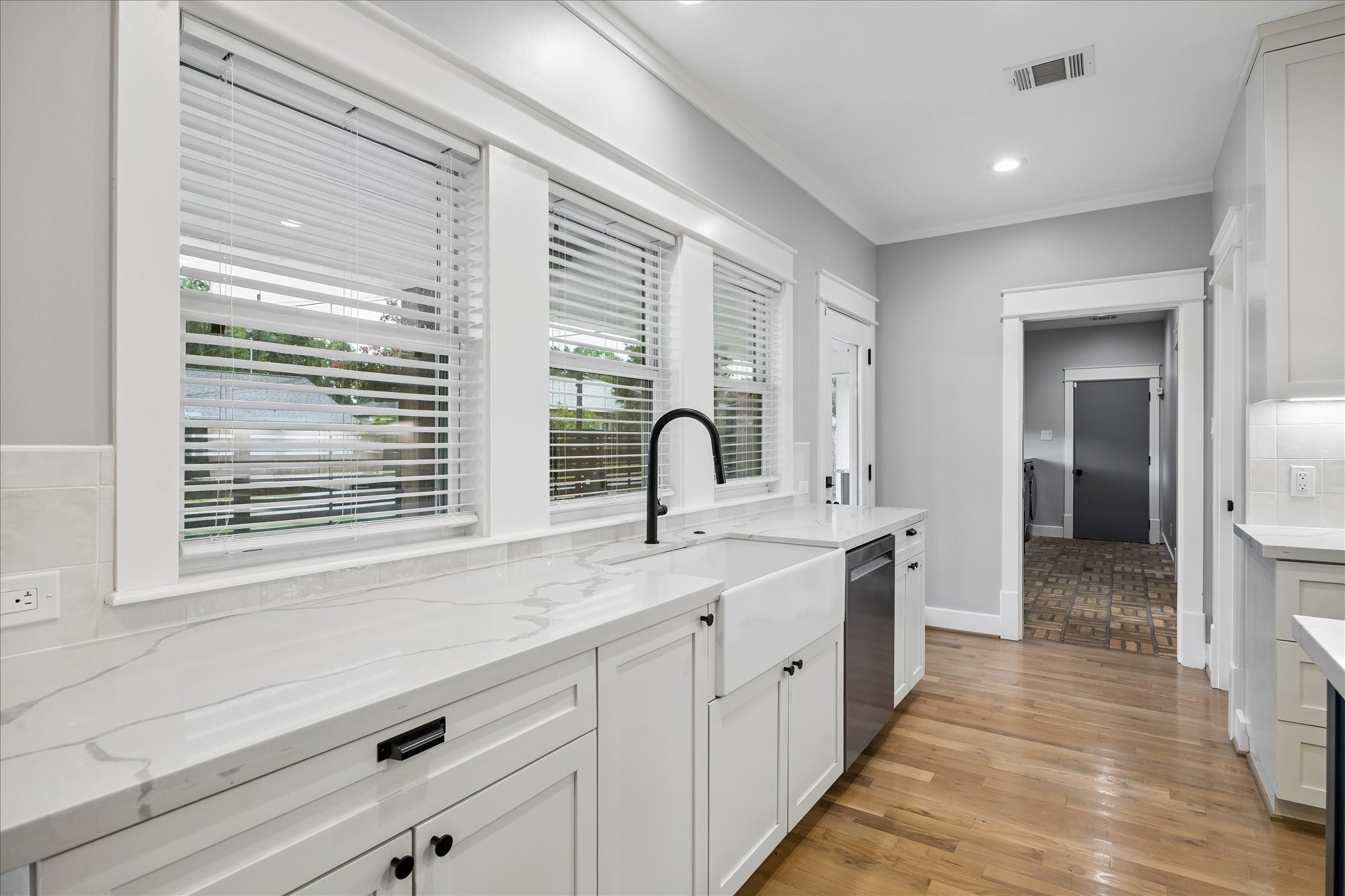 1205 Temple Street Houston, TX 77009 - Photo 15 of 33 Windows overlooking the yard fill the kitchen with sunlight, making everyday moments feel bright, connected, and inviting.