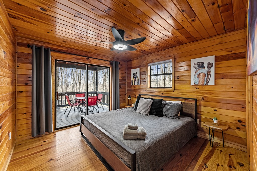 403 Sugar Mountain Road Blue Ridge, GA 30513 - Photo 22 of 84 a bedroom with a bed and wooden floor