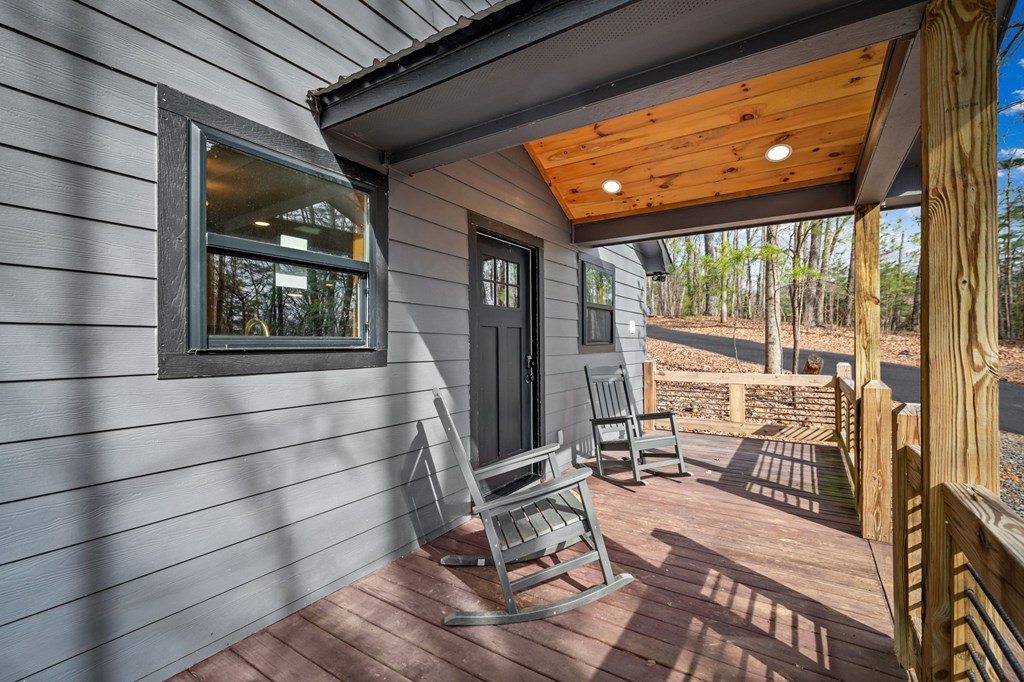 403 Sugar Mountain Road Blue Ridge, GA 30513 - Photo 45 of 84 a view of a porch with wooden floor and furniture