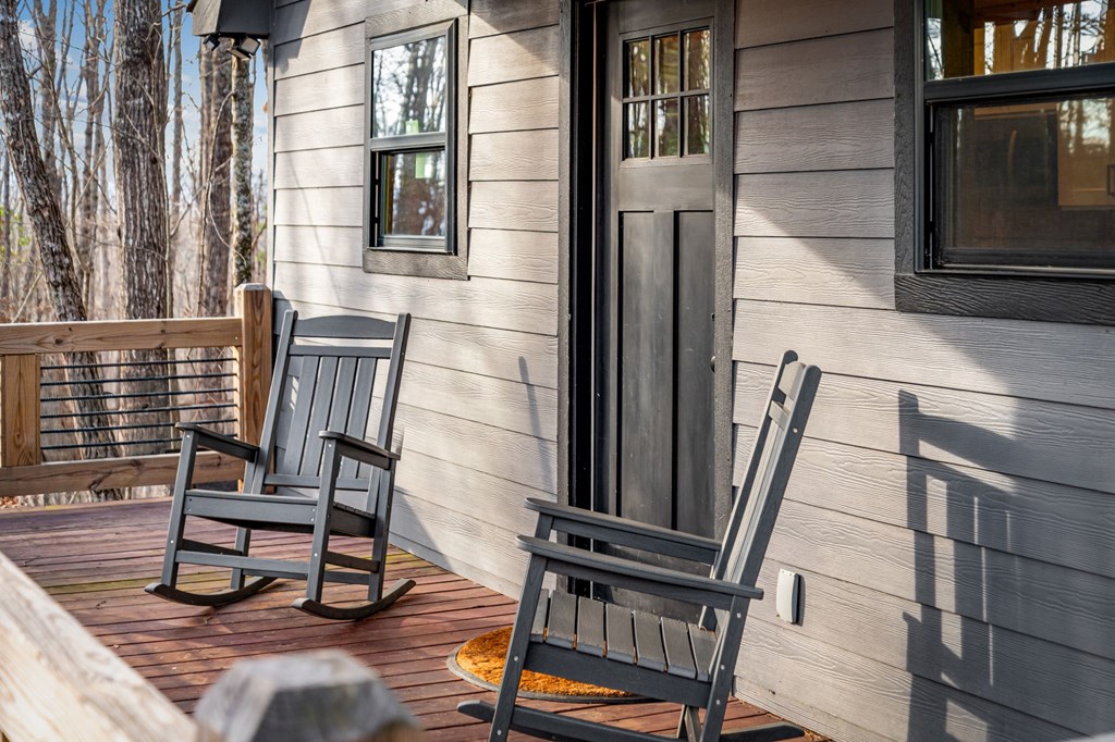 403 Sugar Mountain Road Blue Ridge, GA 30513 - Photo 67 of 84 a view of a balcony with chairs and wooden floor
