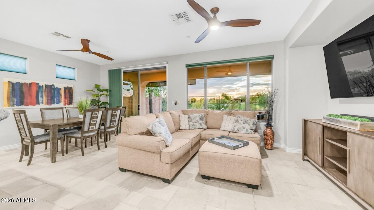 41902 North Crooked Stick Road Anthem, AZ 85086 - Photo 11 of 41 a living room with furniture a flat screen tv and a fireplace