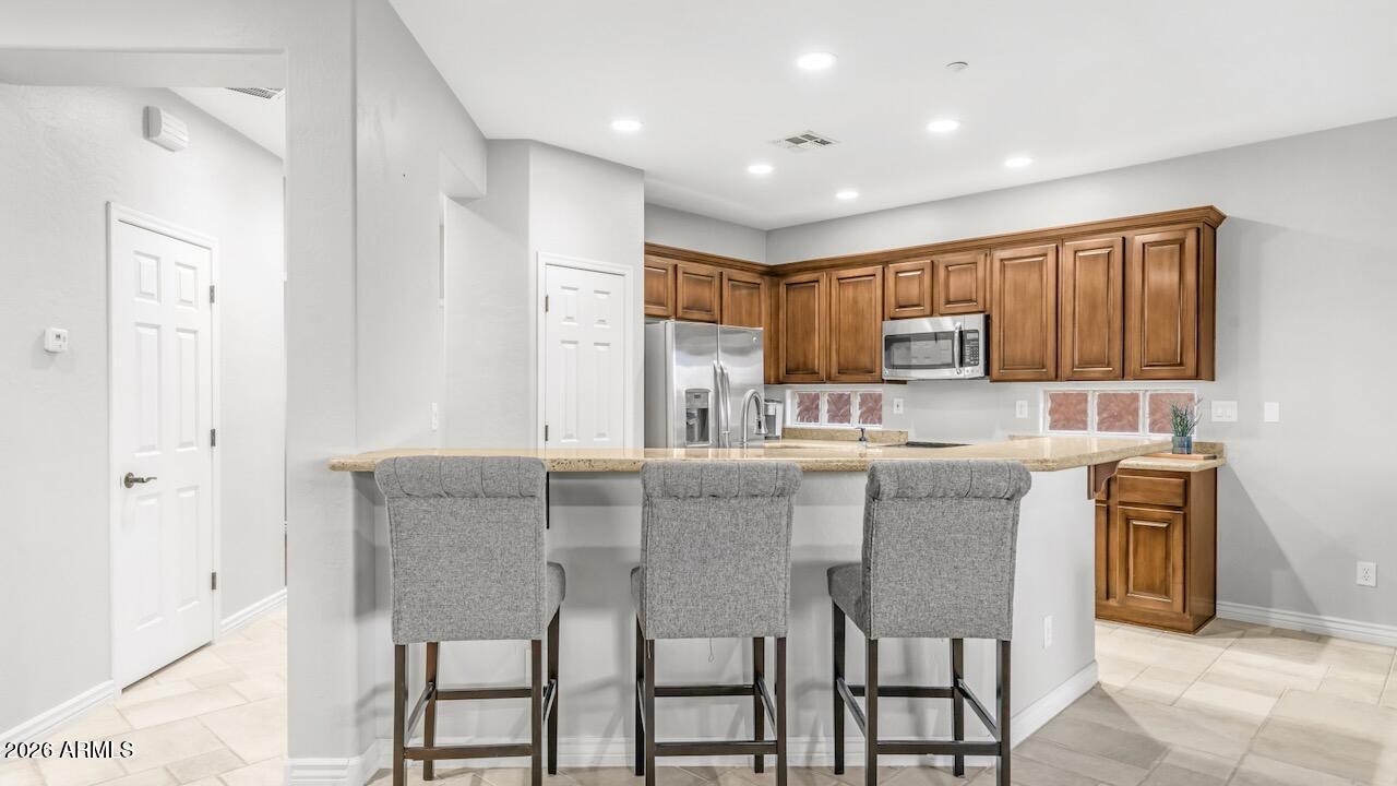 41902 North Crooked Stick Road Anthem, AZ 85086 - Photo 16 of 41 a kitchen with granite countertop cabinets and refrigerator