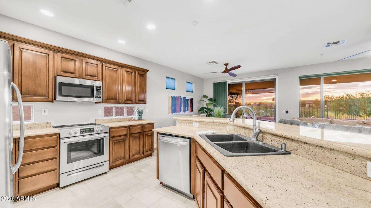41902 North Crooked Stick Road Anthem, AZ 85086 - Photo 17 of 41 a kitchen that has a sink and a stove top oven