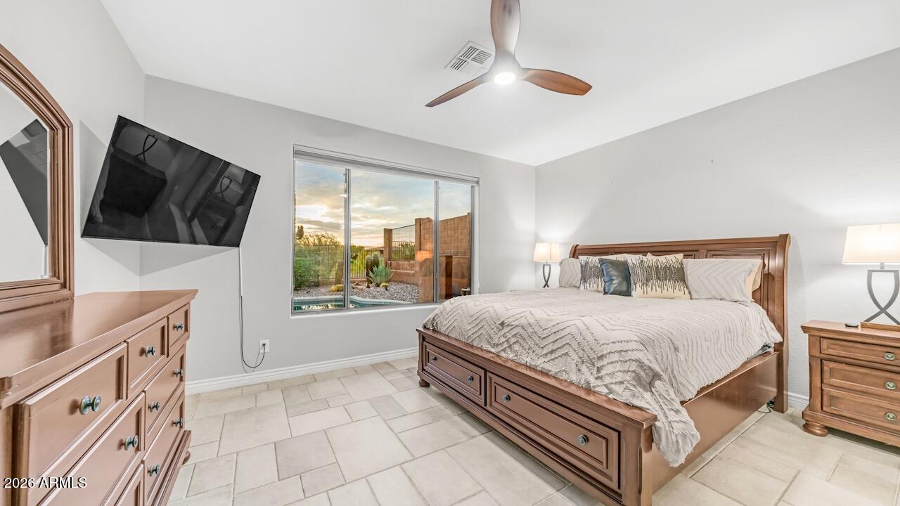 41902 North Crooked Stick Road Anthem, AZ 85086 - Photo 18 of 41 a bedroom with a large bed and a flat tv screen on dresser