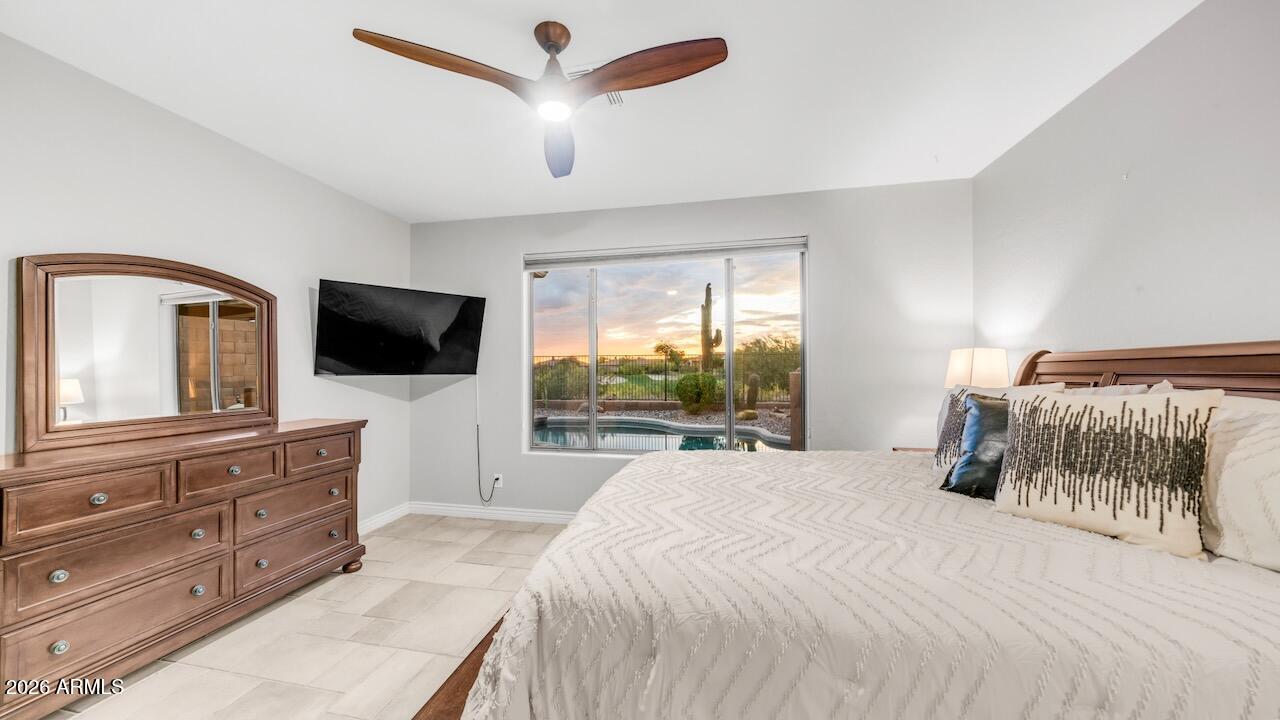 41902 North Crooked Stick Road Anthem, AZ 85086 - Photo 20 of 41 a bedroom with a large bed and a flat screen tv