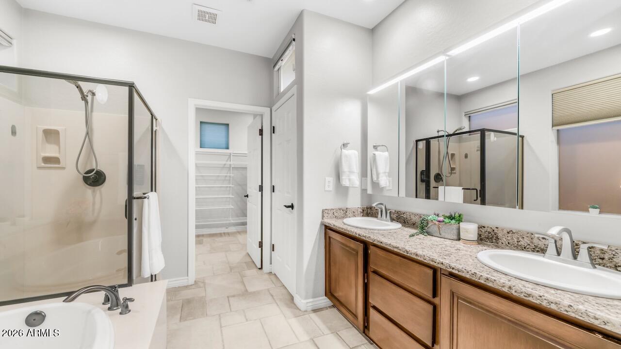 41902 North Crooked Stick Road Anthem, AZ 85086 - Photo 22 of 41 a spacious bathroom with a granite countertop sink mirror and shower
