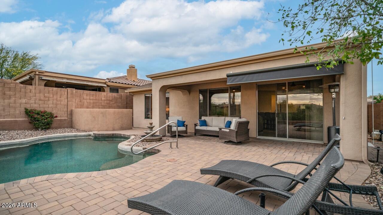 41902 North Crooked Stick Road Anthem, AZ 85086 - Photo 24 of 41 a view of a patio with table and chairs and potted plants with sky view