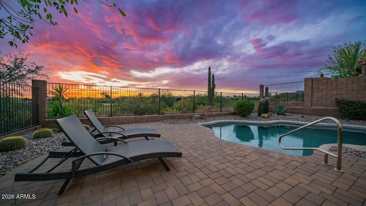 41902 North Crooked Stick Road Anthem, AZ 85086 - Photo 29 of 41 a view of a lake with furniture and a table and chairs