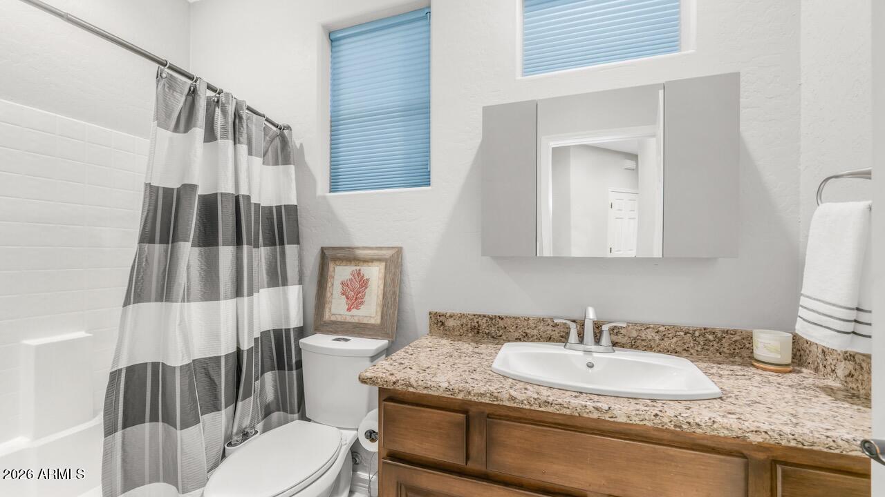 41902 North Crooked Stick Road Anthem, AZ 85086 - Photo 8 of 41 a bathroom with a granite countertop toilet sink and mirror