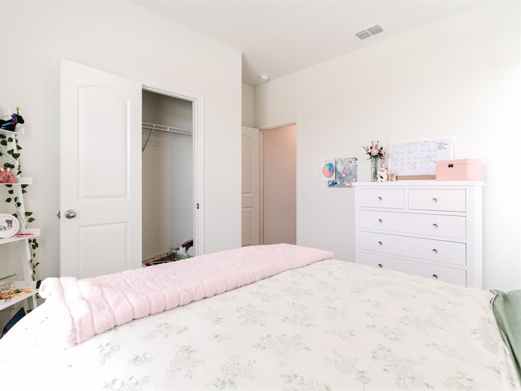 608 Aqueduct Drive Seagoville, TX 75159 - Photo 13 of 20 a bedroom with a bed and closet