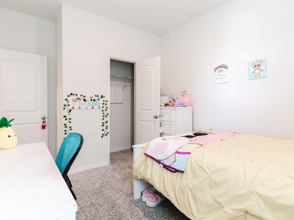 608 Aqueduct Drive Seagoville, TX 75159 - Photo 18 of 20 a bedroom that has a bed and a chair in it